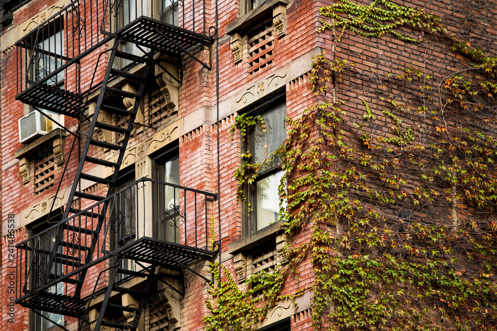 Close-up view of New York City style apartment buildings with emergency stairs along Mott Street in Chinatown neighborhood of Manhattan, New York, United States..