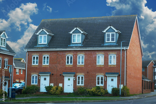 Corby, United Kingdom - 01 January 2019. Traditional english house, brick house. Outdoor, street view. Blue sky.