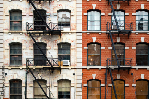 Close-up view of New York City style apartment buildings with emergency stairs along Mott Street in Chinatown neighborhood of Manhattan, New York, United States.. photo
