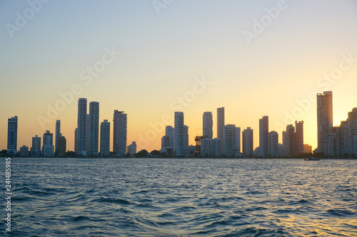 Cartagena   Colombia - 12 25 2018  Panoramic view of the coastline of the city and the sea with blue sky with some boats or ships with a sunset and buildings