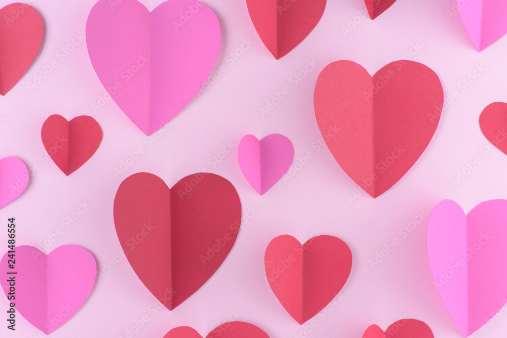 Red and pink paper hearts, valentine day background.