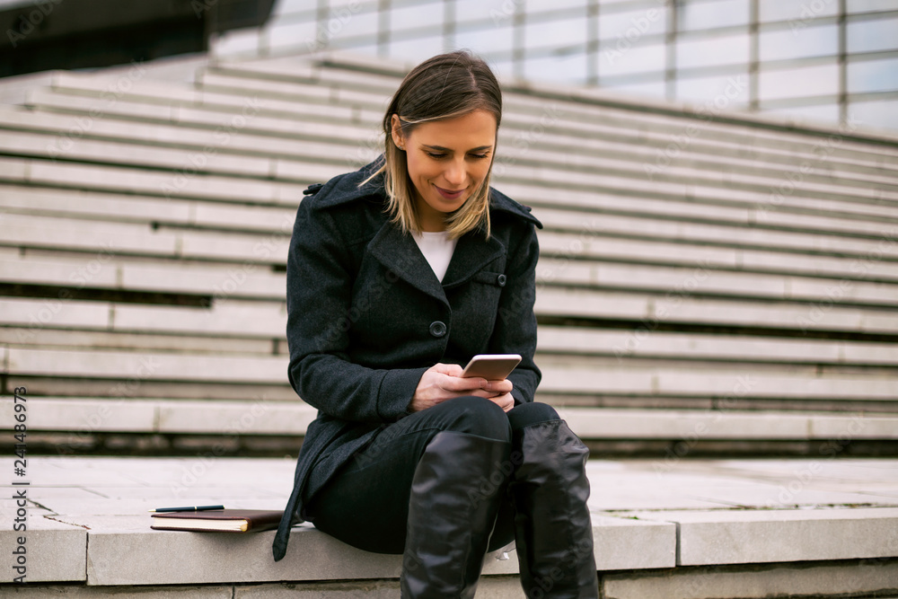 Businesswoman using mobile phone.