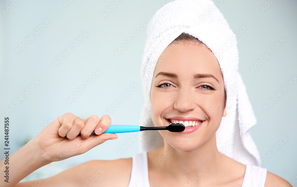 Portrait of young woman with toothbrush on blurred background Portrait of young woman with toothbrush on blurred background