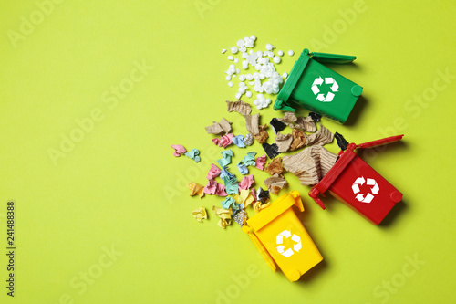 Photos Trash bins and different garbage on color background, top view with space for text