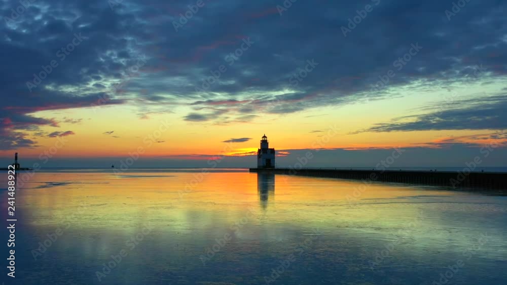 Iconic Lighthouse standing tall in frozen Lake Michigan harbor, Winter dawn. Iconic Lighthouse standing tall in frozen Lake Michigan harbor, Winter dawn.