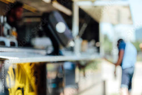 Unfocused image of a man ordering food in a food truck