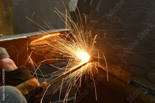 Fototapeta Welding welding workers strike out sparks