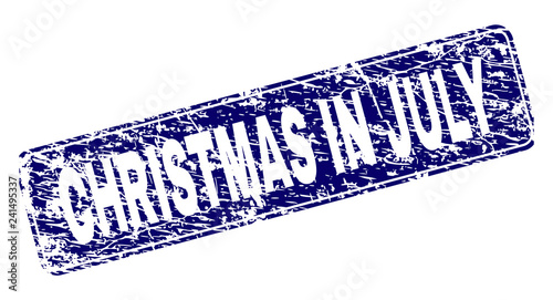 CHRISTMAS IN JULY stamp seal imprint with grunge style. Seal shape is a rounded rectangle with frame. Blue vector rubber print of CHRISTMAS IN JULY tag with grunge style.