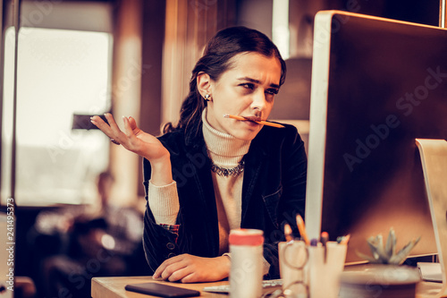 Attentive young office worker checking her email