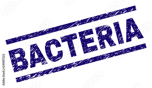 BACTERIA seal print with scratced style. Blue vector rubber print of BACTERIA text with dust texture. Text tag is placed between parallel lines.