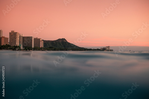 A pink sky forms as the sunsets off of Diamond Head on Oahu Hawaii photo