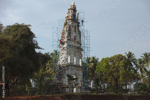 3146 Workers on scaffolding next to old church facade in Goa, Dec. 6, 2017