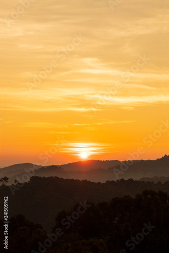 silhouette of mountains with sunrise background
