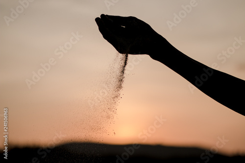 The sand falls off the hand.