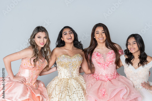 Four Hispanic Girls In Quinceanera Dresses