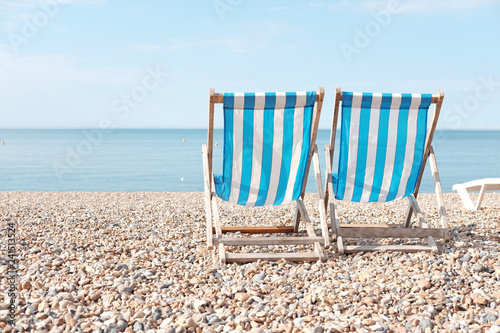 Two stripe beach chair on a beach.