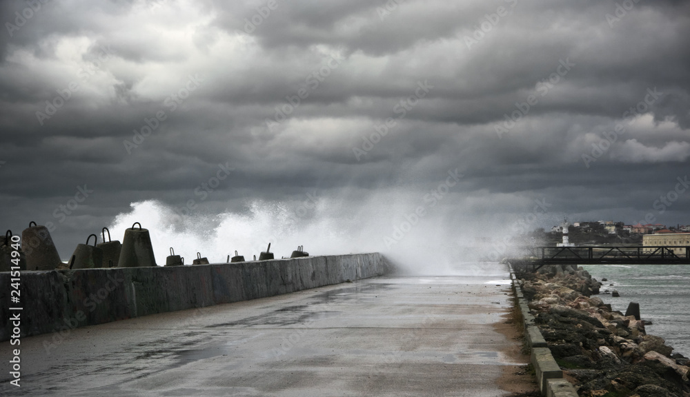 Stormy surf breaking on breakwater