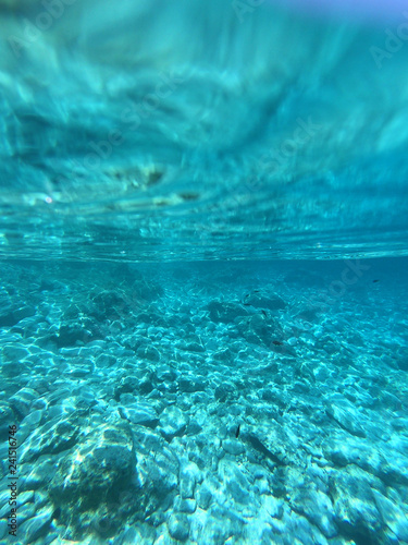 Underwater photo of exotic paradise island bay with turquoise clear sea
