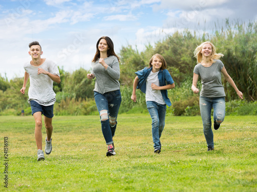 Group of teenagers running in park