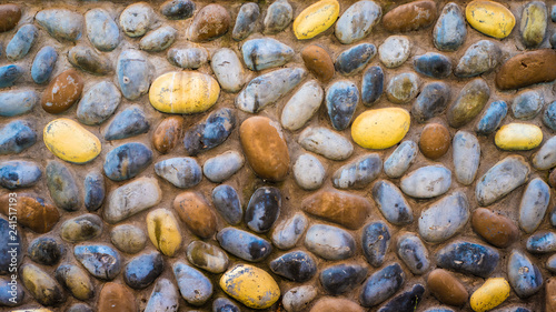 Obraz na plátně Bright summer sea pebble stones on the beach near ocean texture background