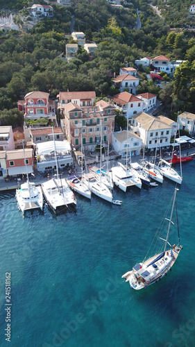 Aerial drone bird's eye view photo of iconic small safe port of Gaios with traditional Ionian architecture and sail boats docked, Paxos island, Ionian, Greece