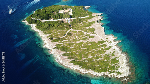 Aerial drone bird s eye view photo of sail boats docked in tropical caribbean paradise bay with white rock caves and turquoise clear sea