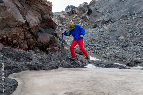 Man with ice ax moving over the glacier