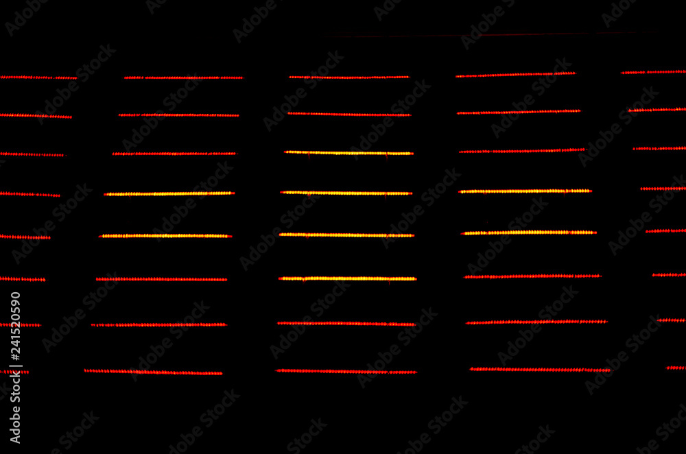 Sparkly red and yellow lights decoration in horizontal lines.