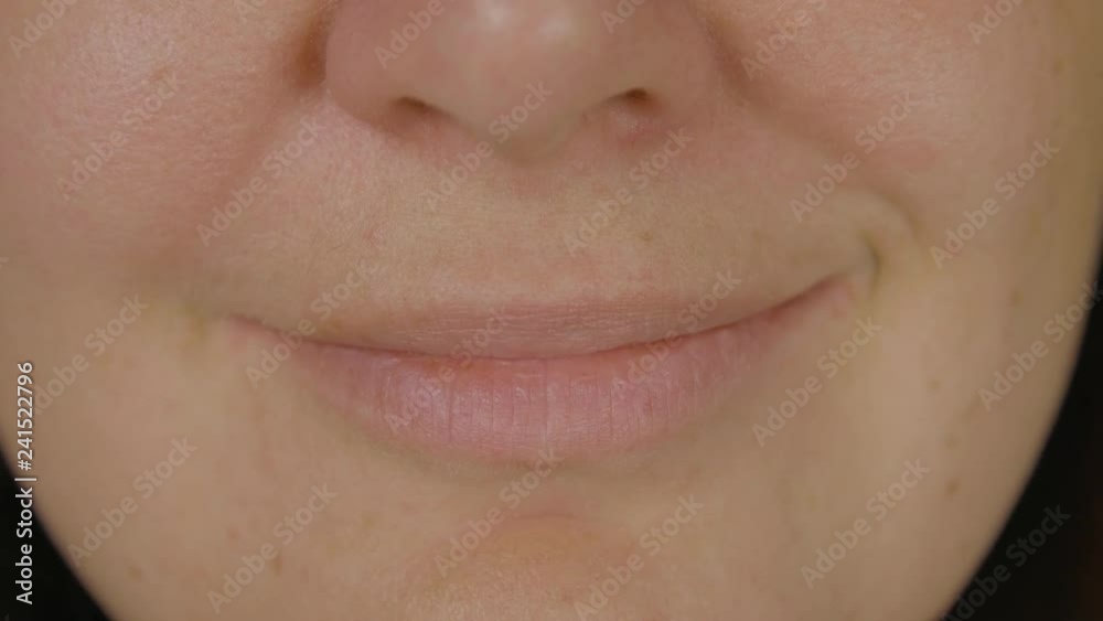 Female face, mouth and smiling lips close up. Face adult woman smiling by lips front camera. Expression people emotion concept Female face, mouth and smiling lips close up. Face adult woman smiling by lips front camera. Expression people emotion concept