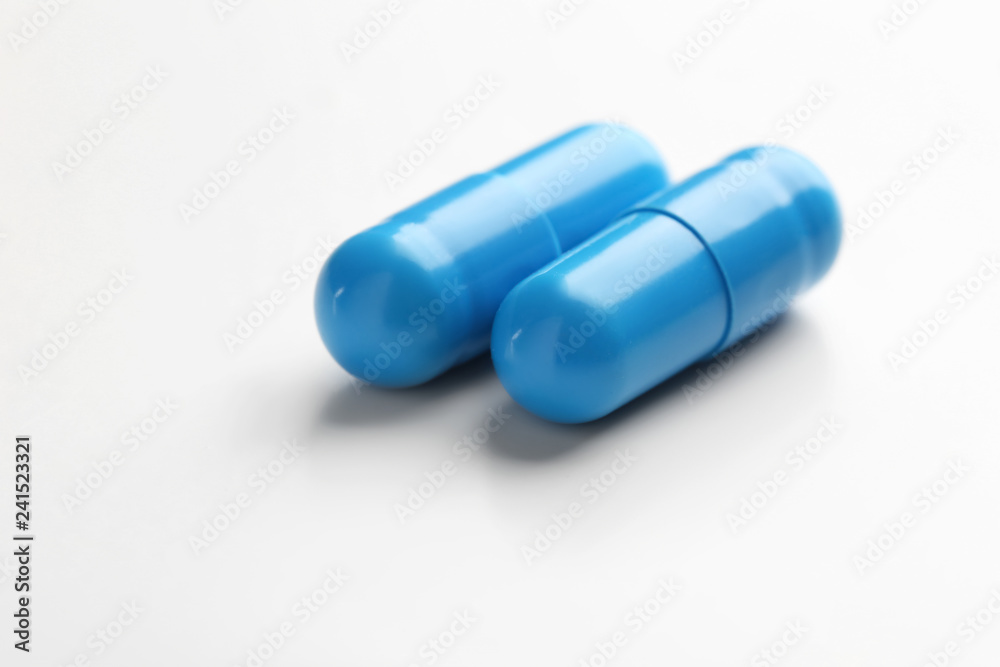 Colorful pills on white background