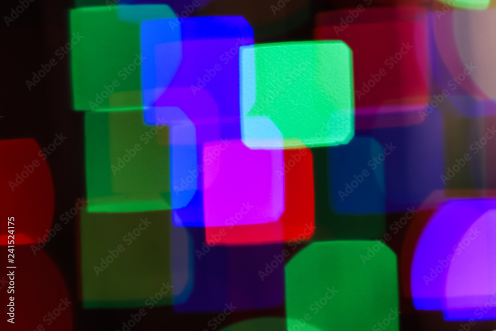 Blurred view of beautiful lights on dark background