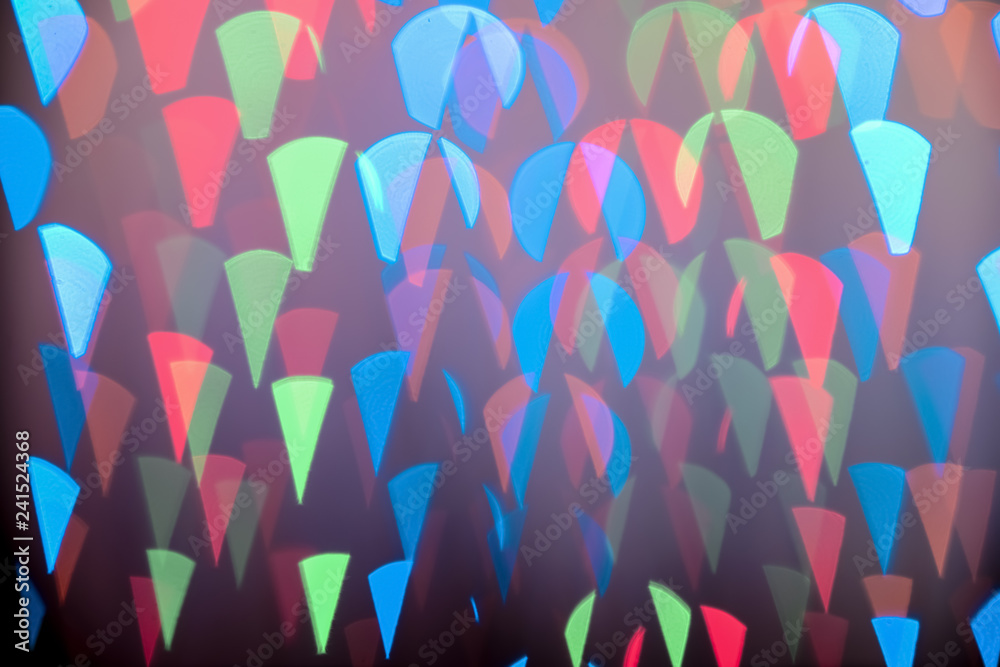 Blurred view of beautiful lights on dark background