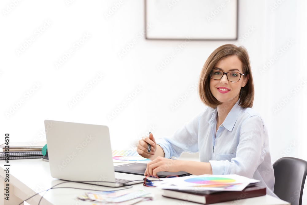 Beautiful young designer working in office Beautiful young designer working in office