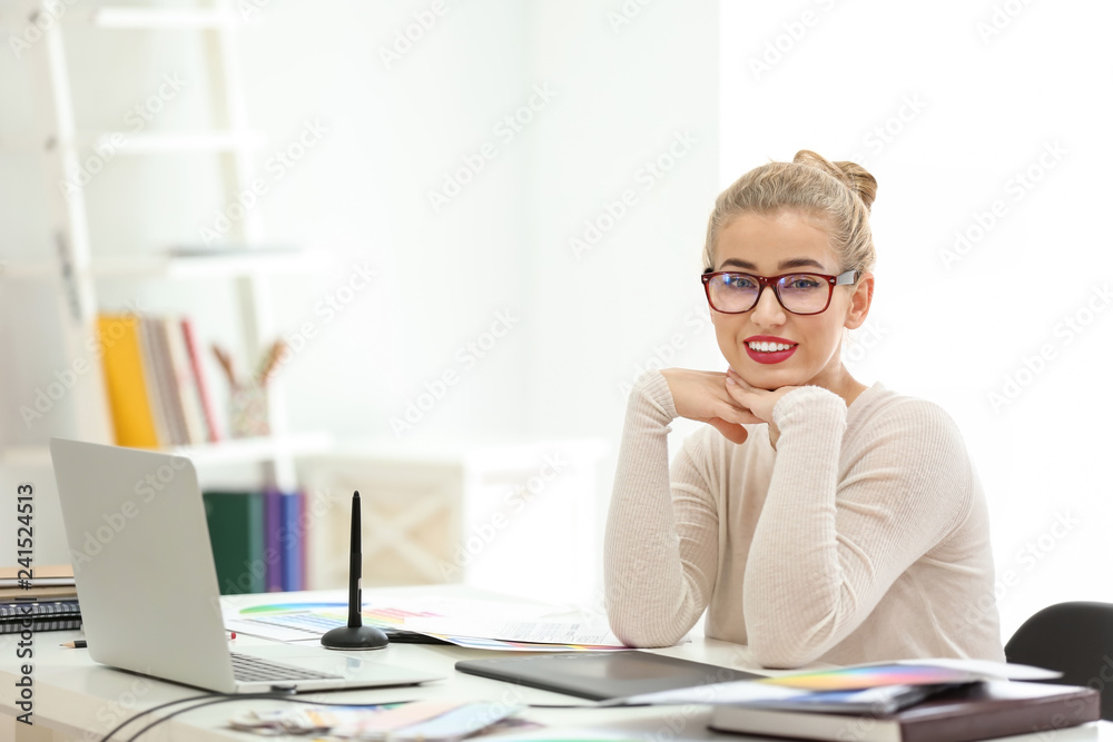 Beautiful young designer working in office Beautiful young designer working in office