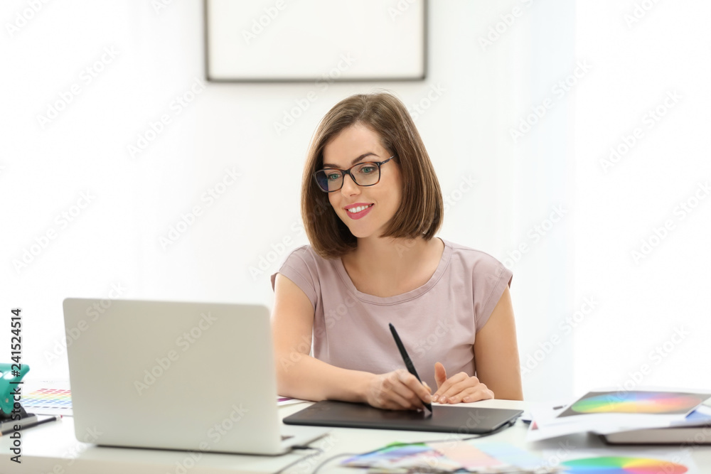 Beautiful young designer working in office Beautiful young designer working in office