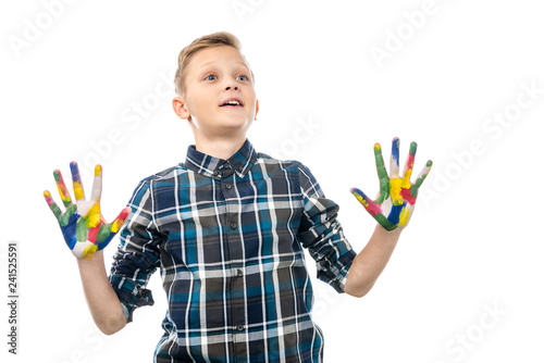 surprised boy with hands painted in colorful paints isolated on white