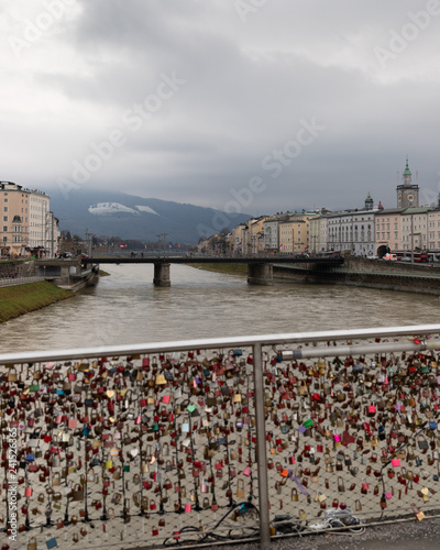 Love locks (padlocks) and snowy mountains view from a bridge in Salzburg, Austria