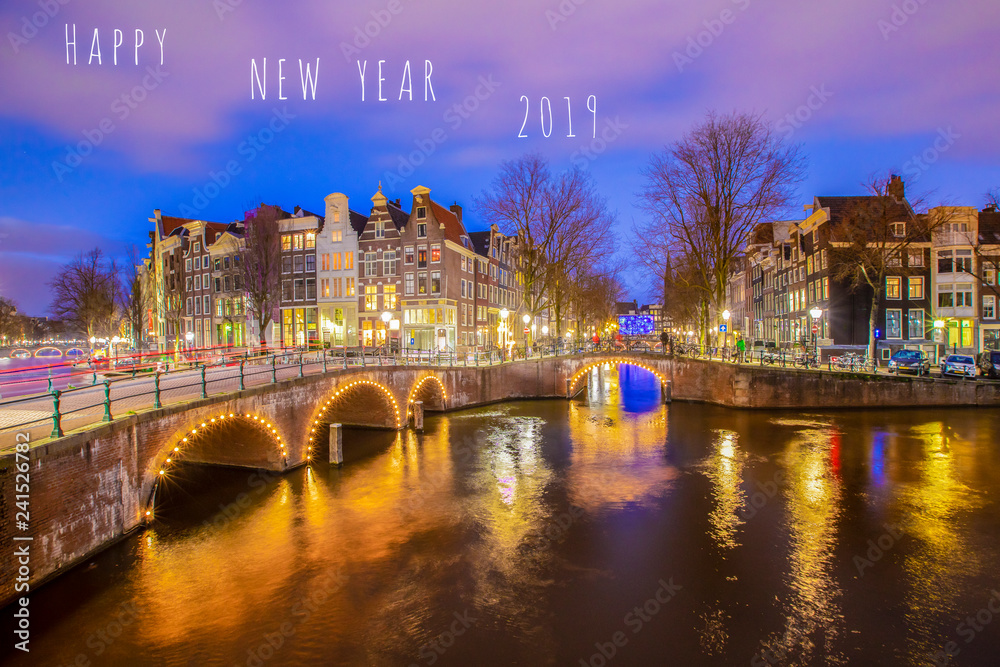 Happy New year 2019 greeting card with English text with view on Amsterdam romantic canal at night