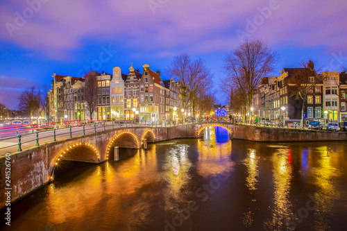 View on romantic canal Leidsegracht in Amsterdam at night with city lights  bridges and reflection on water