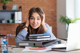 Stressed businesswoman missing deadlines in office