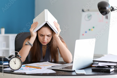 Tired businesswoman trying ...