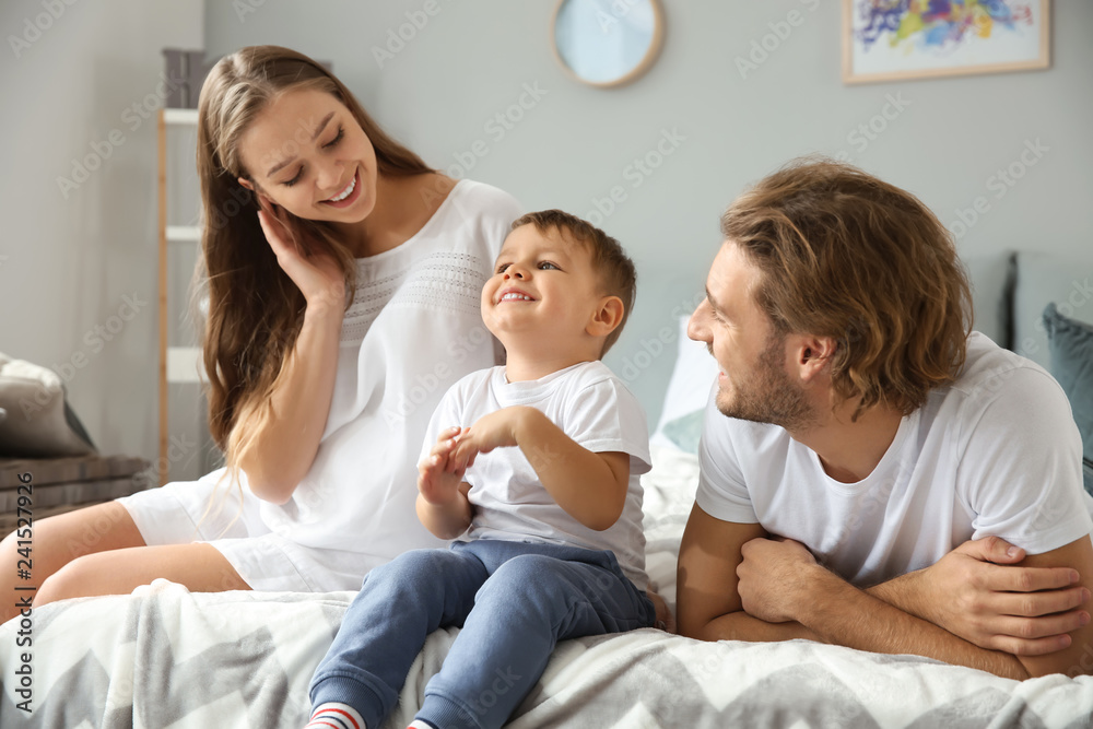 Young pregnant woman with her family in bedroom Young pregnant woman with her family in bedroom