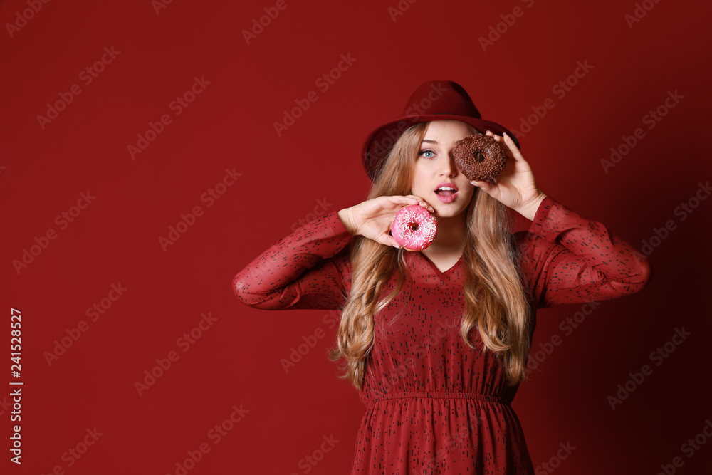 Funny young woman with tasty donuts on color background Funny young woman with tasty donuts on color background