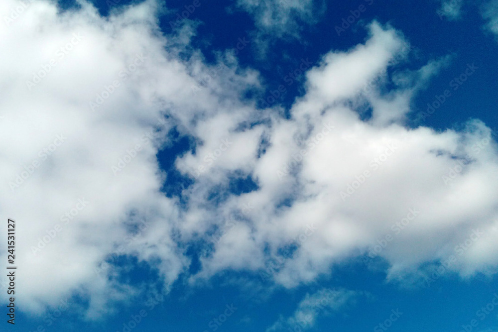 Fototapeta premium white fluffy clouds on blue sky for background