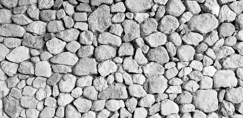 Gray stone or rock wall for background in black and white style - Abstract or Art wallpaper, Surface, Floor, Design and Exterior decoration concept 
