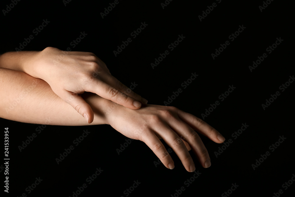 Fototapeta premium Female hands on dark background