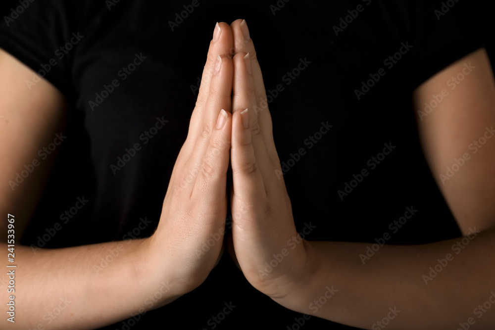 Praying young woman, closeup
