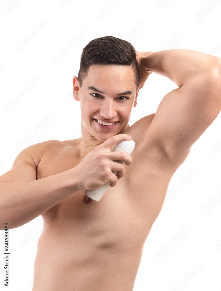 Young man using deodorant on white background Young man using deodorant on white background