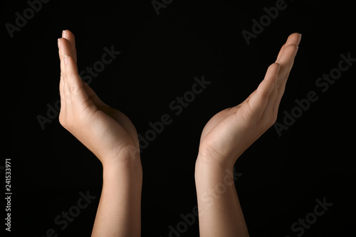Female hands on dark background