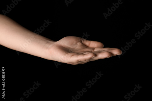 Female hand on dark background